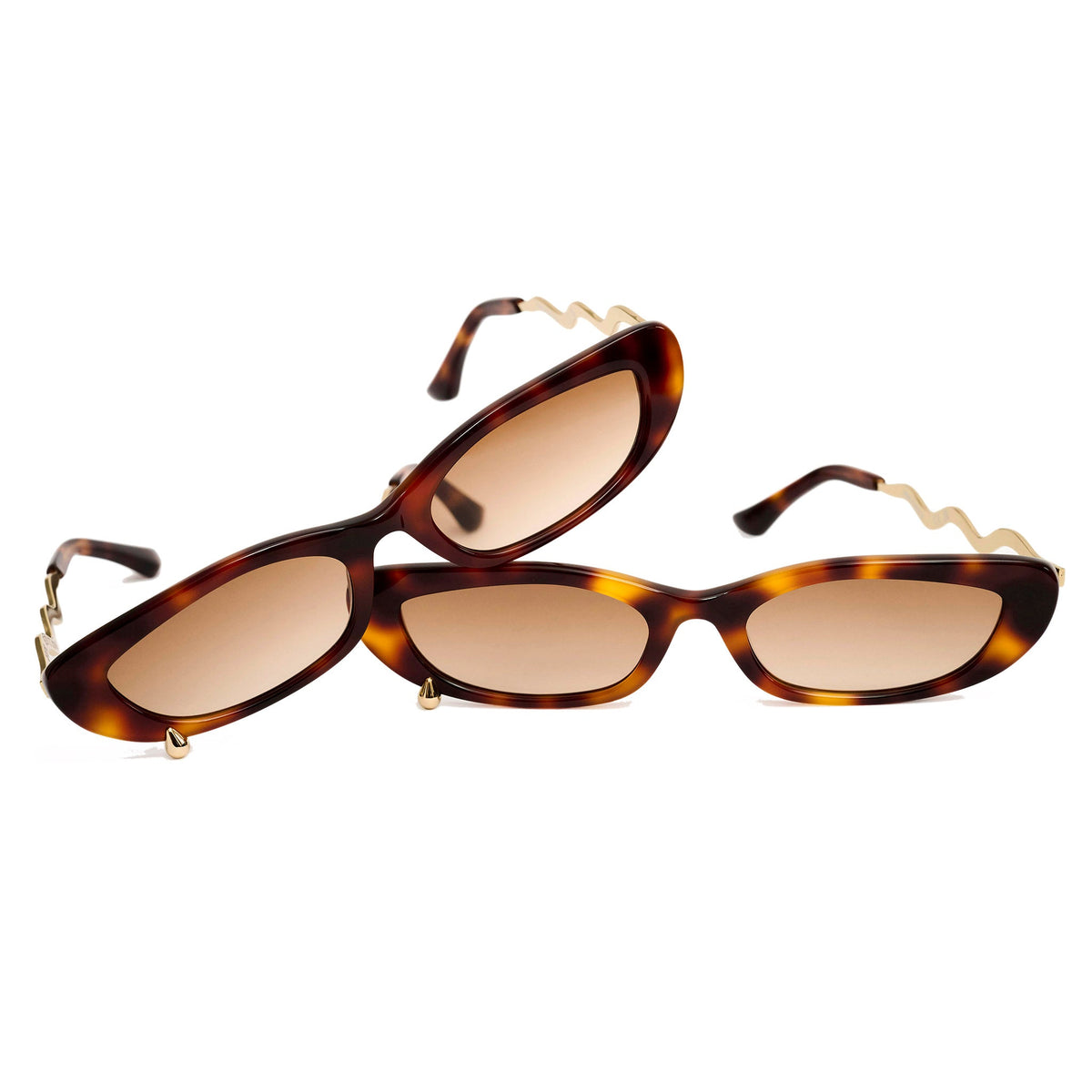 Two pairs of cat-eye sunglasses with tortoiseshell frames and warm brown lenses, displayed on a clean white background.